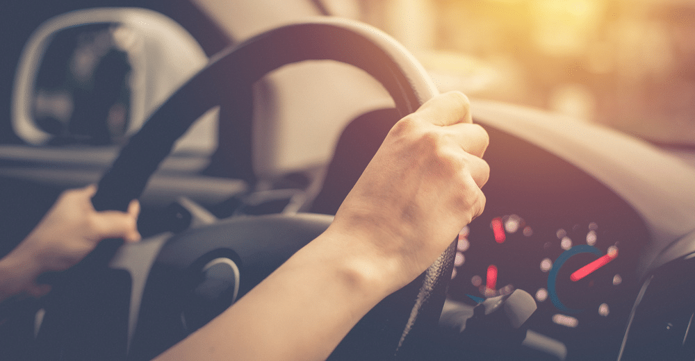 Spring Car Care tips for Drivers in Maumelle and North Little Rock, AR at Cantrell Service Center. Image of a female hands on the steering wheel of her car and dashboard while driving.