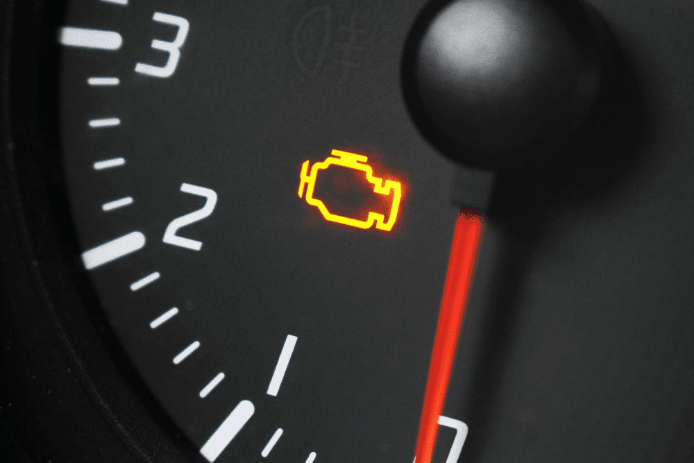 Close-up of a flashing check engine light on a car’s RPM gauge. auto repair in north little rock at Cantrell Service Center.