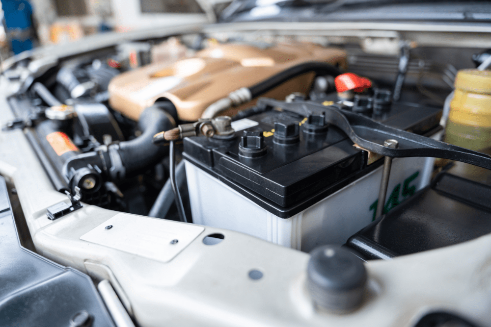 Fall car maintenance, auto repair in North Little Rock, AR by Cantrell Service Center. Image of a vehicle battery under the hood, highlighting the importance of reliable electrical service to ensure safety and dependable performance during seasonal change.