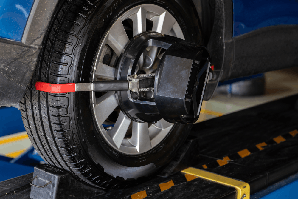 Wheel alignment, auto repair in Maumelle, AR by Cantrell Service Center. Image of a vehicle tire mounted with alignment equipment on a lift rack, highlighting precise suspension adjustments for improved handling, tire life, and safe driving performance.
